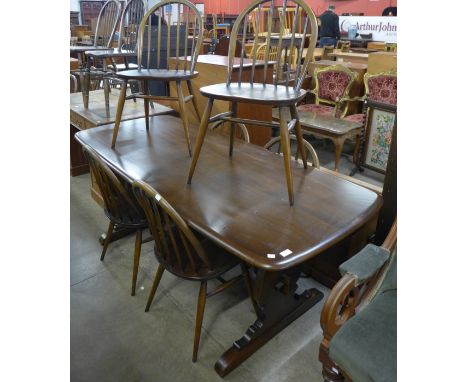 An Ercol Golden Dawn elm refectory table and six Windsor chairs 