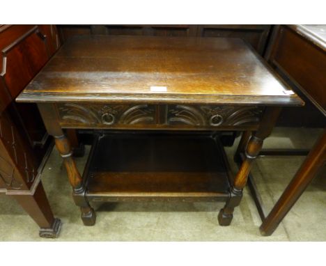 A carved oak single drawer hall table 