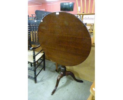 A George III oak circular tilt-top tripod tea table 