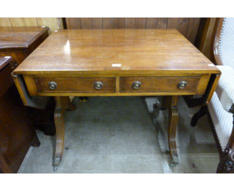 A Regency style inlaid mahogany and yew wood sofa table 