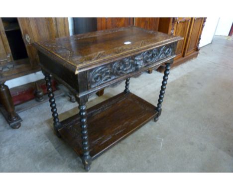 A 17th Century style carved oak single drawer Greenman side table 