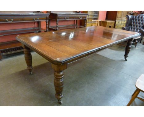 A Victorian oak extending dining table 