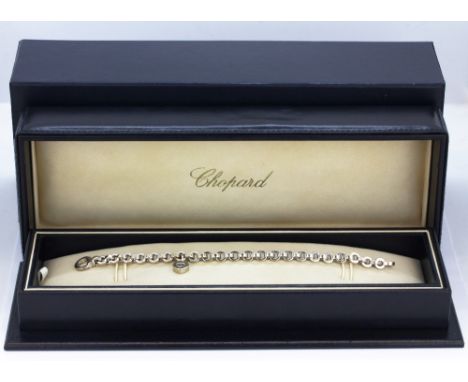 An 18ct white gold (stamped 750) Chopard Happy diamonds bracelet set with a brilliant cut diamond, approx. L. 23cm. In origin