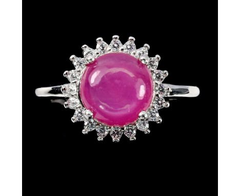 A matching 925 silver ring  with a cabochon cut ruby and white stones, (M.5).