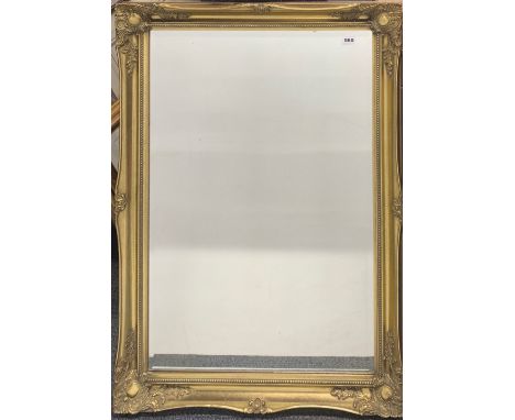 A large gilt framed bevelled mirror, 75cm x 108cm.