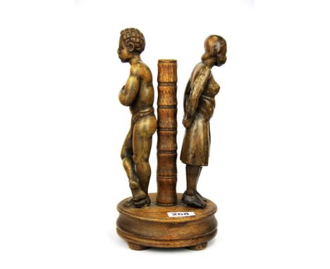 A 19th century carved oak group of two black figures standing beside a post, possibly a lamp base, H. 32cm.