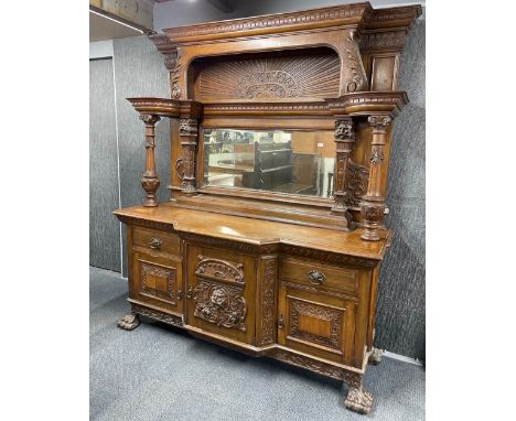 A very impressive large 19th Century mirror backed sideboard, with lions paw feet and column supports, W. 196cm, H. 240cm.