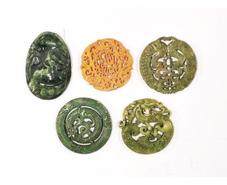 A carved pebble jade dragon pocket amulet H. 8.5cm. together with four further carved stone amulets.