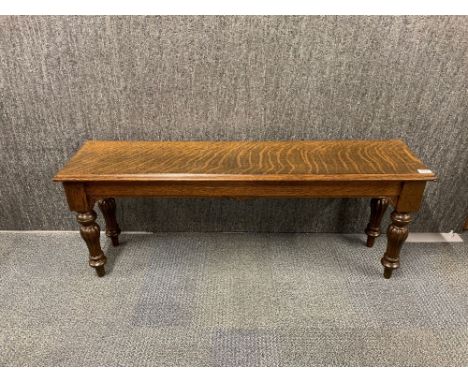 A heavy quality carved oak bench, L. 122cm.