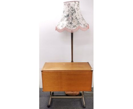 A 1970's teak bar trolley with drop front, 81 x 37 x 70cm. together with a wooden standard lamp.