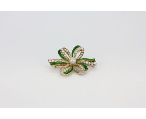 A yellow metal (tested minimum 9ct gold) green enamelled brooch set with old cut diamonds and a cultured pearl, approx. L. 4c