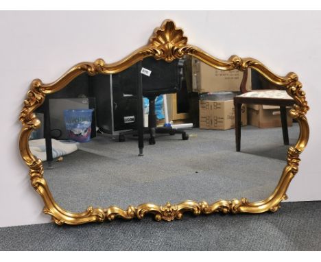 A large ornate gilt framed over mantle mirror, W. 122cm, H. 86cm.