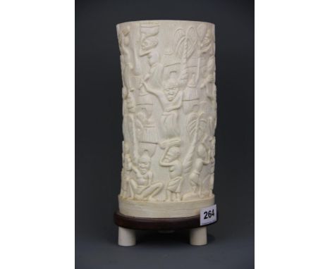 An early 20th Century African carved ivory table lamp, the bulb creating a cameo effect when lit. H. 29cm.