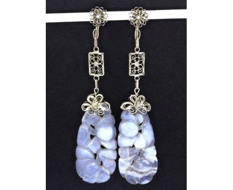 A pair of white metal filigree drop earrings set with carved grey jade, L.7cms