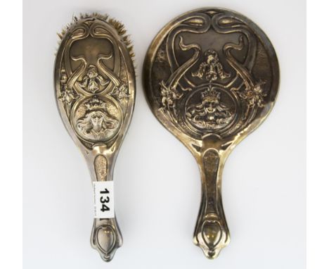 An Art Nouveau hallmarked silver hand mirror and brush.