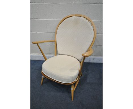 AN ERCOL MODEL 317 ELM AND BEECH GRANDFATHER CHAIR, with cream loose cushions (condition report: -minor surface scratches, sm