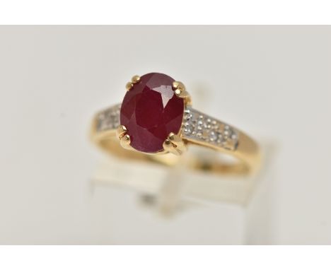 AN 18CT GOLD RUBY AND DIAMOND RING, set with an oval cut ruby, four claw set, flanked with single cut diamond detailed should