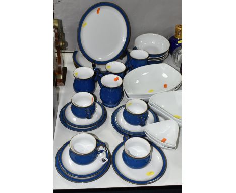 A DENBY IMPERIAL BLUE FOUR PLACE DINNER SET, comprising cups, saucers, mugs, dinner plates, side plates and bowls, together w