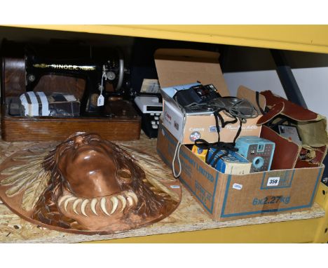 A BOX OF VINTAGE CAMERAS, TYPEWRITER, SEWING MACHINE AND WALL PLAQUE, comprising a wooden cased treadle Singer sewing machine