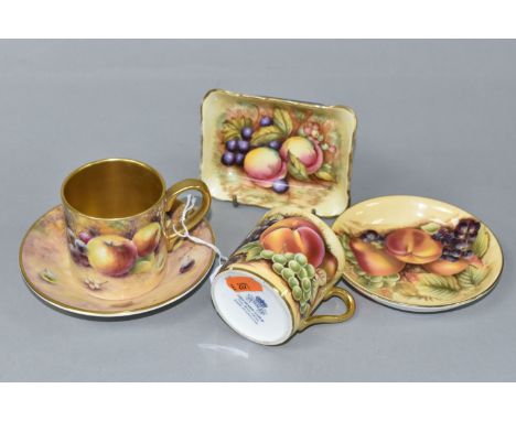 A COFFEE CAN AND SAUCER HAND PAINTED BY ROYAL WORCESTER ARTIST BRYAN COX, painted with apples, grapes, plums and berries on a