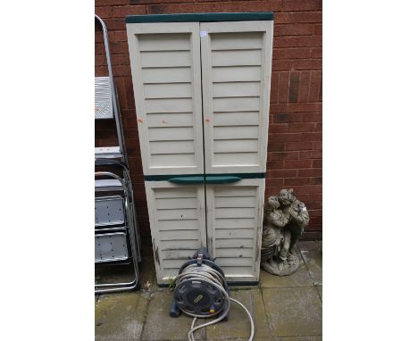 A PLASTIC TWO DOOR GARDEN CUPBOARD, along with a hose lock hose and reel (2) (condition: plastic joints need attention, top c