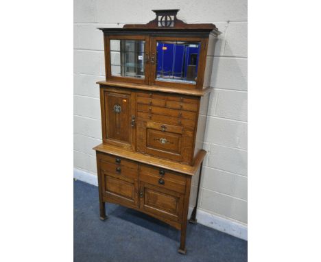 AN ARTS AND CRAFTS OAK MEDICAL / MEDICINE CABINET, labelled 'premier cabinet co', with an arrangement of mirrored, glazed and