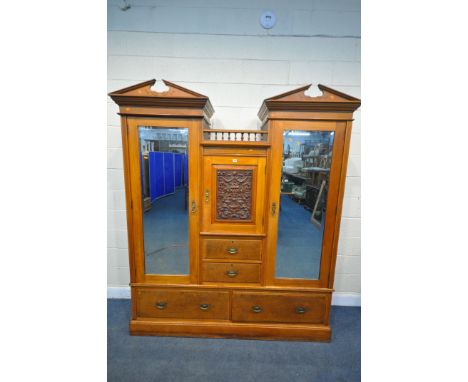 AN EDWARDIAN SATINWOOD COMPACTUM WARDROBE, with an arrangement of three cupboards with bevelled mirrors, and a foliate panel 