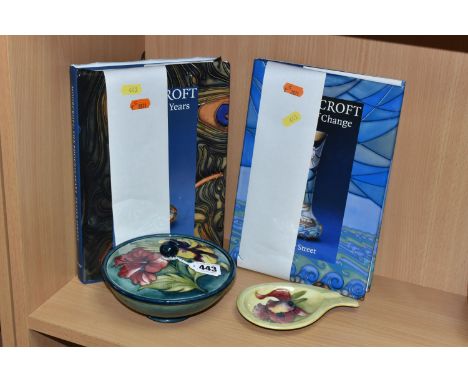 A MOORCROFT POTTERY COVERED BOWL, ASHTRAY AND TWO BOOKS, comprising a covered bowl tube lined with pink and yellow Hibiscus o
