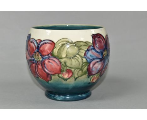 A MOORCROFT POTTERY PLANTER, of rounded form, tube lined with a pink and purple Clematis pattern on a graduated cream to turq