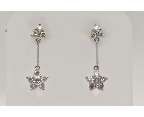 A PAIR OF 18CT WHITE GOLD DIAMOND DROP EARRINGS, each earring designed with a diamond set flower drop, suspended from a polis