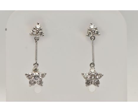 A PAIR OF 18CT WHITE GOLD DIAMOND DROP EARRINGS, each earring designed with a diamond set flower drop, suspended from a polis