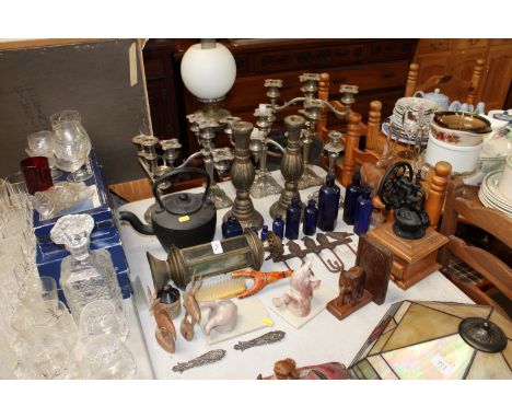 A quantity of silver plated candelabras; a pair of candlesticks, a coffee grinder; book ends; old bottles etc.