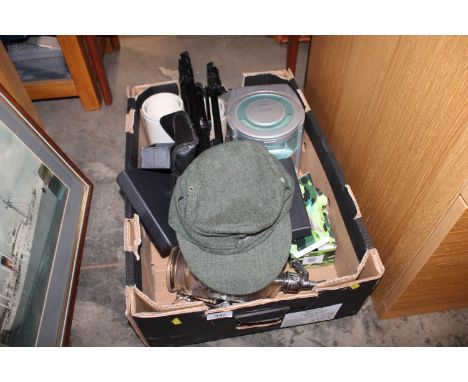 A box containing a German style cap, camera tripod, soda syphon etc.