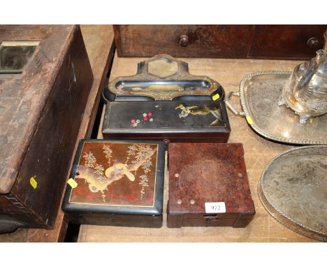 A black lacquered and decorated storage box, a desk stand another black lacquered example together with another trinket box