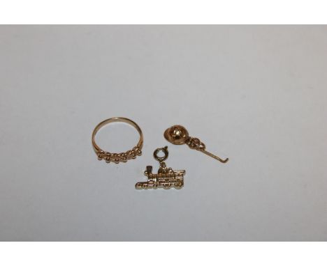 A 9ct gold ring approx. 2.5gms; a 9ct gold charm in the form of a jockeys hat and whip approx. 1gm and a yellow metal charm i