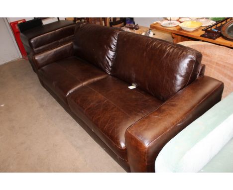 A Next brown leather upholstered three seater sofa