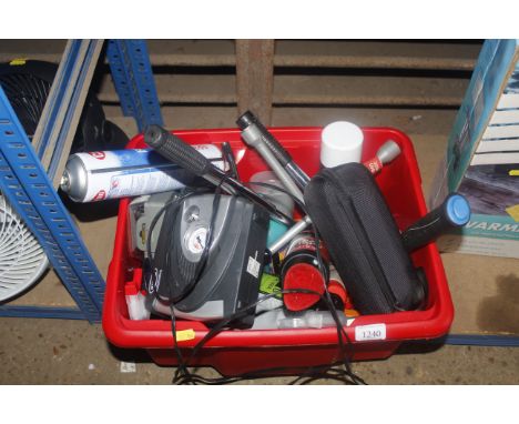 A box containing various automotive tools to include 12V compressor, lug nut wrench, de-icer etc.