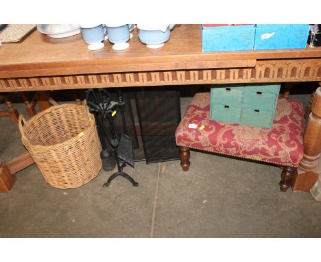 An upholstered footstool, fireguard, companion set, wicker basket and a storage unit