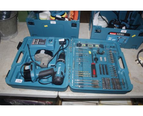 A Makita 8391D drill together with two batteries, charger and cased drill bit set