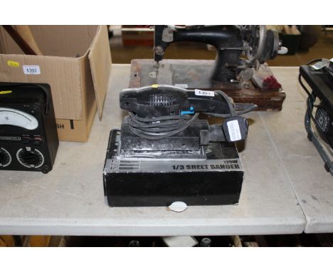 A PowerBase 135W sheet sander with original box