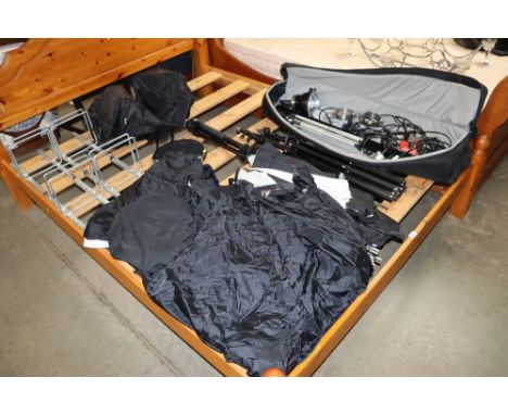 A collection of photographic and lighting equipment including various stands, tripod and accessories