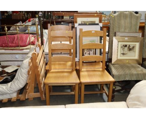 A set of four modern light oak ladder back chairs