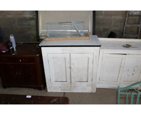 An enamel topped wooden cupboard 