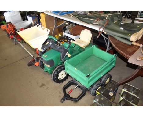 A child's ride along John Deere pedal tractor with loader arm and matching trailer 