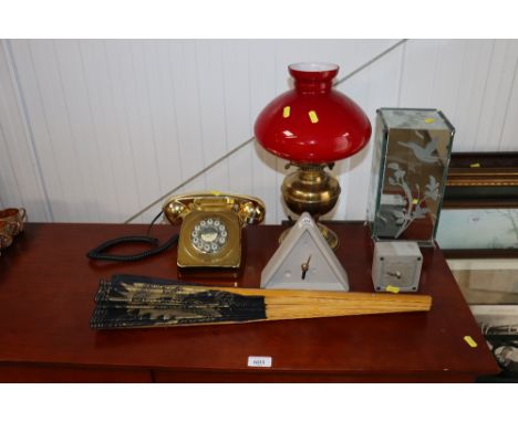A Laura Ashley table lamp, rotary telephone, oil lamp converted to electricity, fan and two clocks
