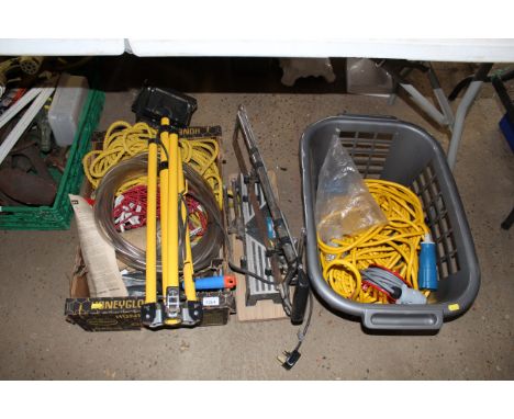 A tray box containing a work light; flexible pipe; a quantity of rope; a mitre saw; and another carte containing a 110V exten
