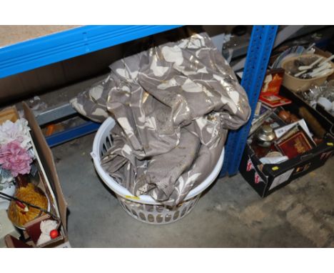 A laundry basket containing pillows and curtains