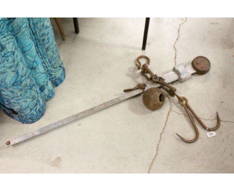 An antique beam scale and weight.