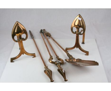 A pair of Copper Art Nouveau andirons decorated with Hearts etc together with a similar companion set.