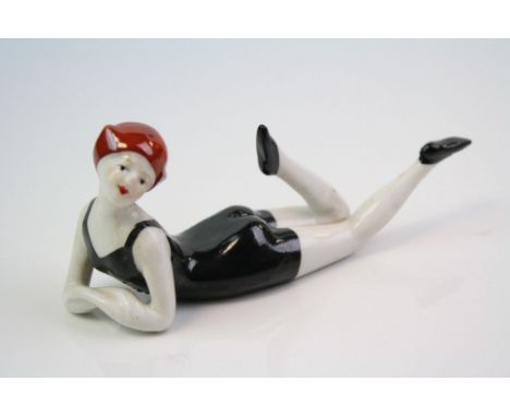 A ceramic figure of a flapper girl 